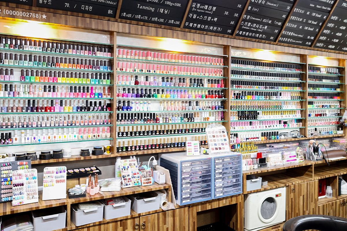 Extensive display of various nail polish colors inside Pro Beauty salon.