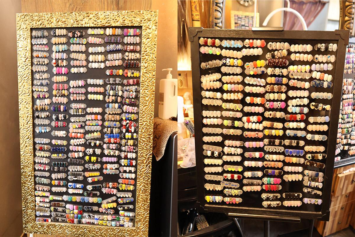 Wide variety of nail art designs displayed on boards inside the nail salon.