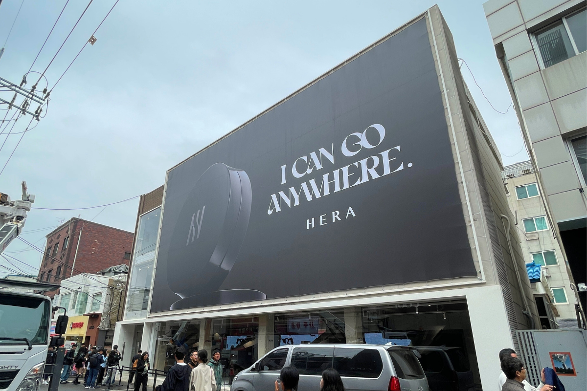 COSRX pop-up event featuring merchandise and brochures held by attendees.