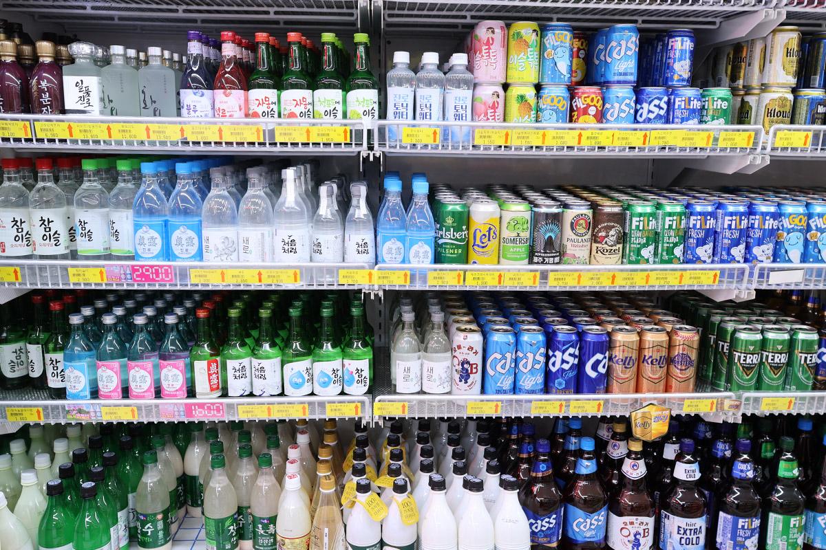 Refrigerators stocked with diverse Korean alcoholic beverages including soju and beer at Hongdae Mart 24 Hours.