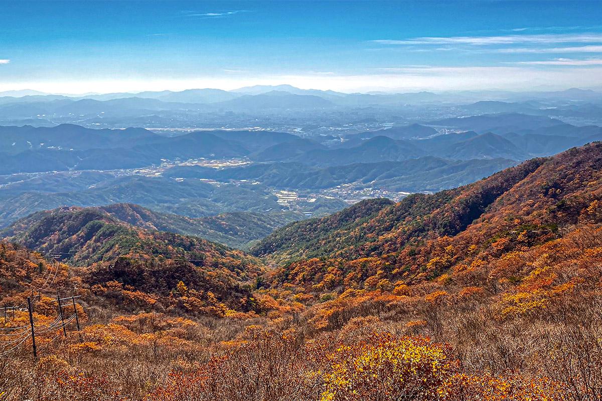 Aerial view over Palgongsan Mountain with sprawling valleys accentuated by autumn colors.