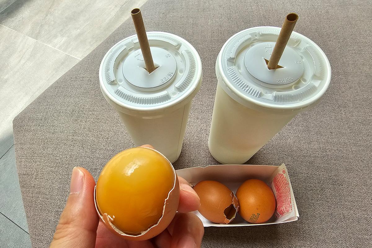 Korean jjimjilbang snack offering of sikhye in cups and boiled eggs, traditional sauna refreshments.