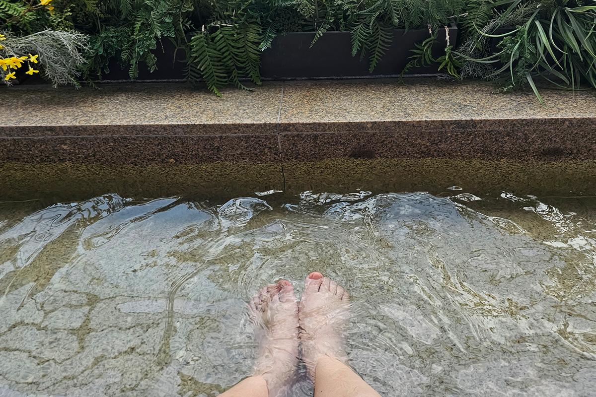 Outdoor foot bath pool area at a Korean jjimjilbang, providing a soothing relaxation spot.