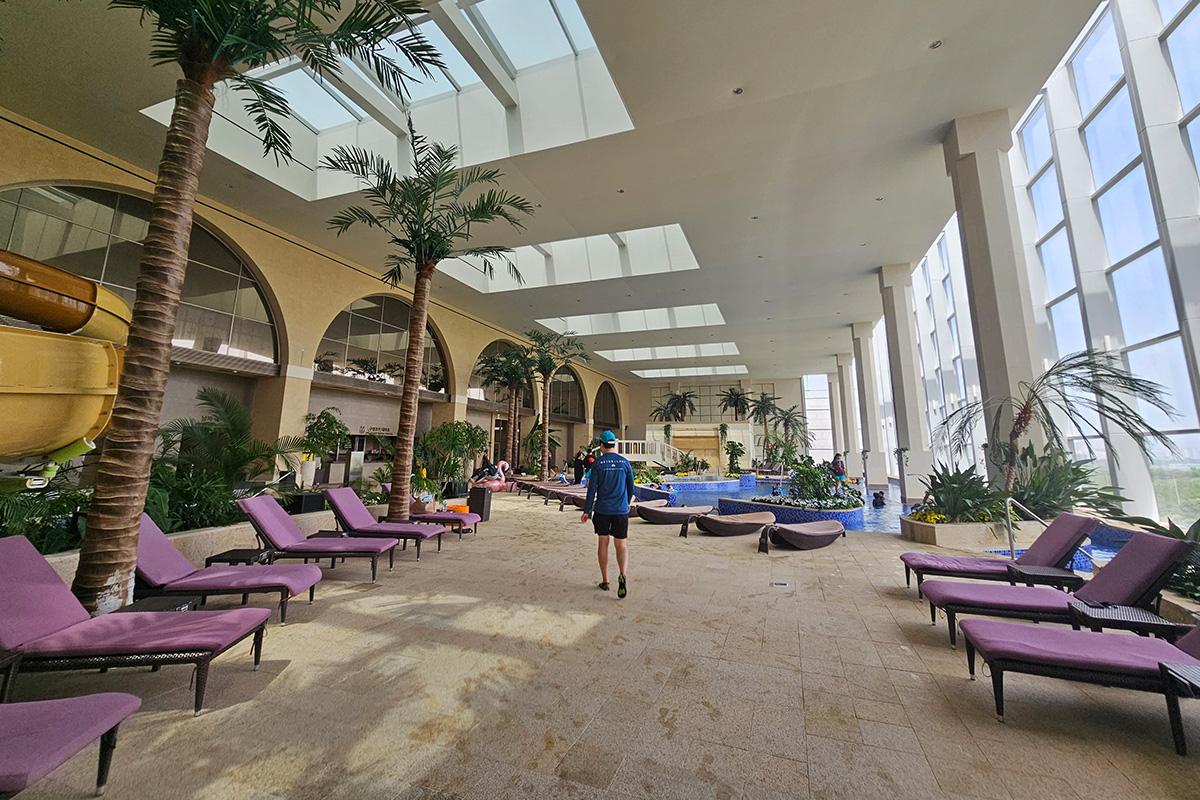 Inviting purple sunbeds arranged in Aqua Field indoor water park relaxation area