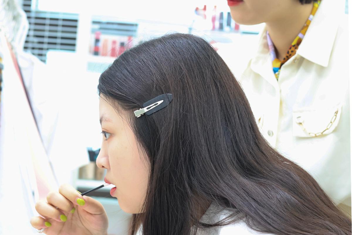 Consultant selecting appropriate lip products in personal color session.
