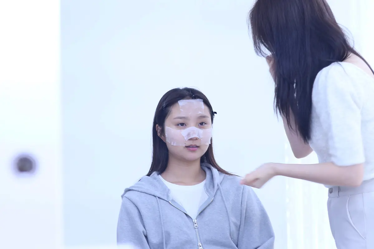 A makeup artist preparing the client