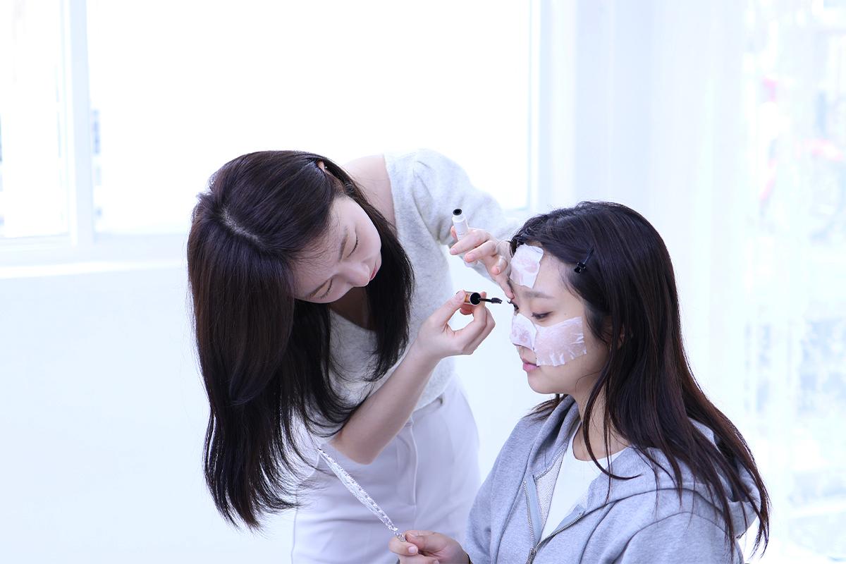 A makeup stylist applying eye makeup with precision as part of the session at Roa Makeup.