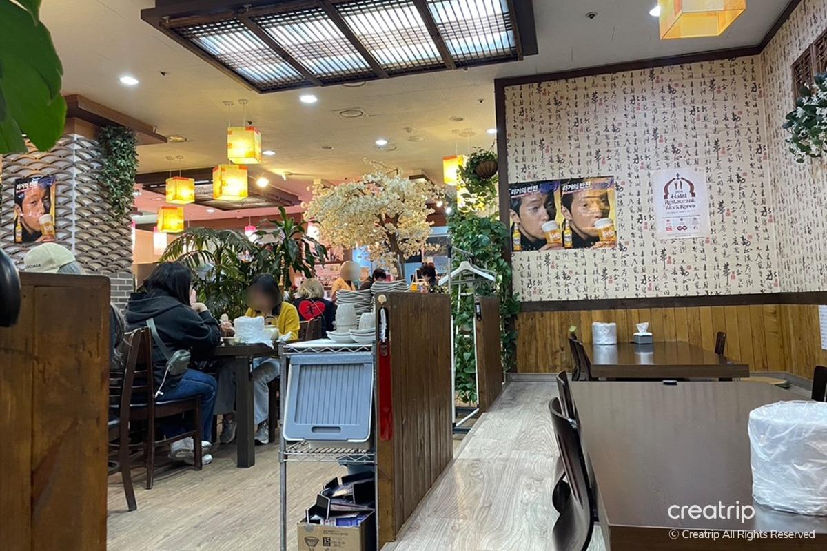 View of the vibrant and bustling interior seating of Hamcho Ganjang Gejang in Myeongdong, Seoul.