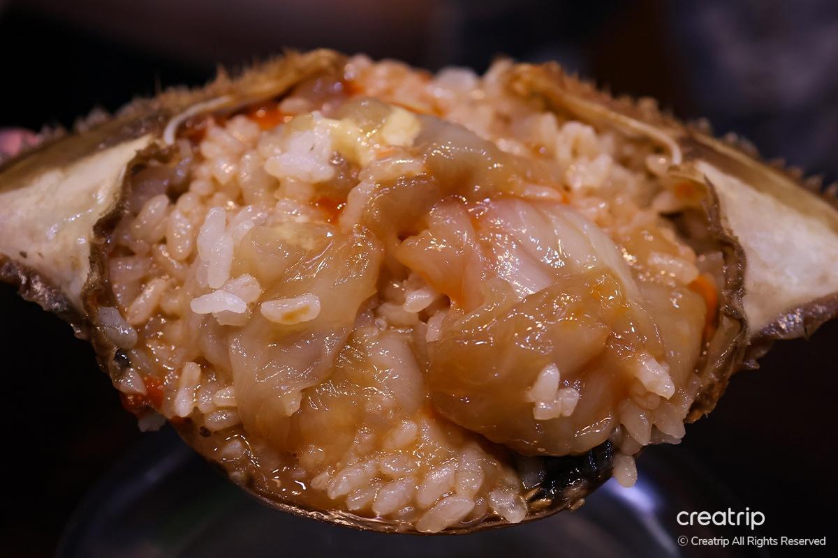 Freshly mixed rice and crab eggs ready to be savored at Hamcho Ganjang Gejang in Myeongdong, Seoul.