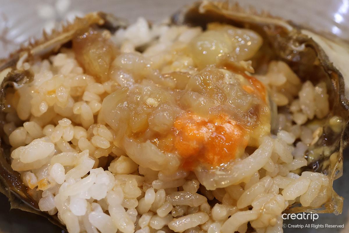 Crab shell filled with rice and crab eggs, showcasing a delectable dish at Hamcho Ganjang Gejang in Myeongdong, Seoul.