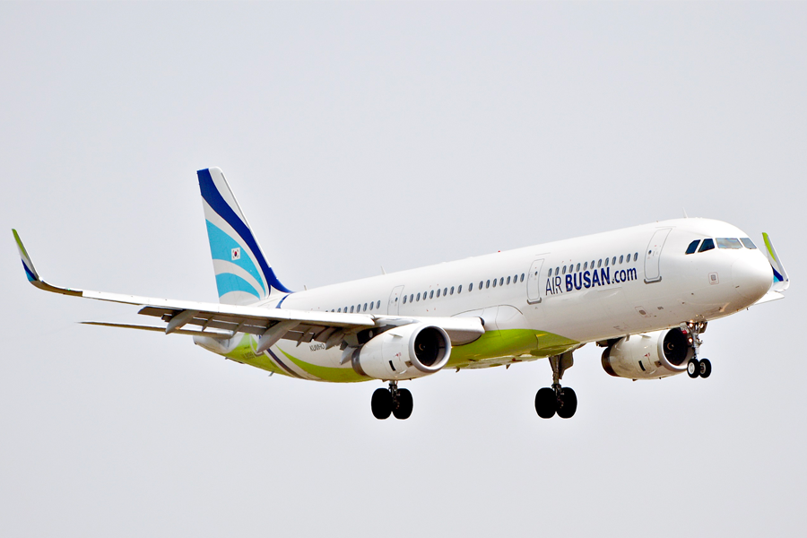 一架Air Busan航空公司的飛機準備降落，圖中可見機翼及飛機外部標識。Air Busan為釜山往返航線提供史上迅速且經濟的選擇。