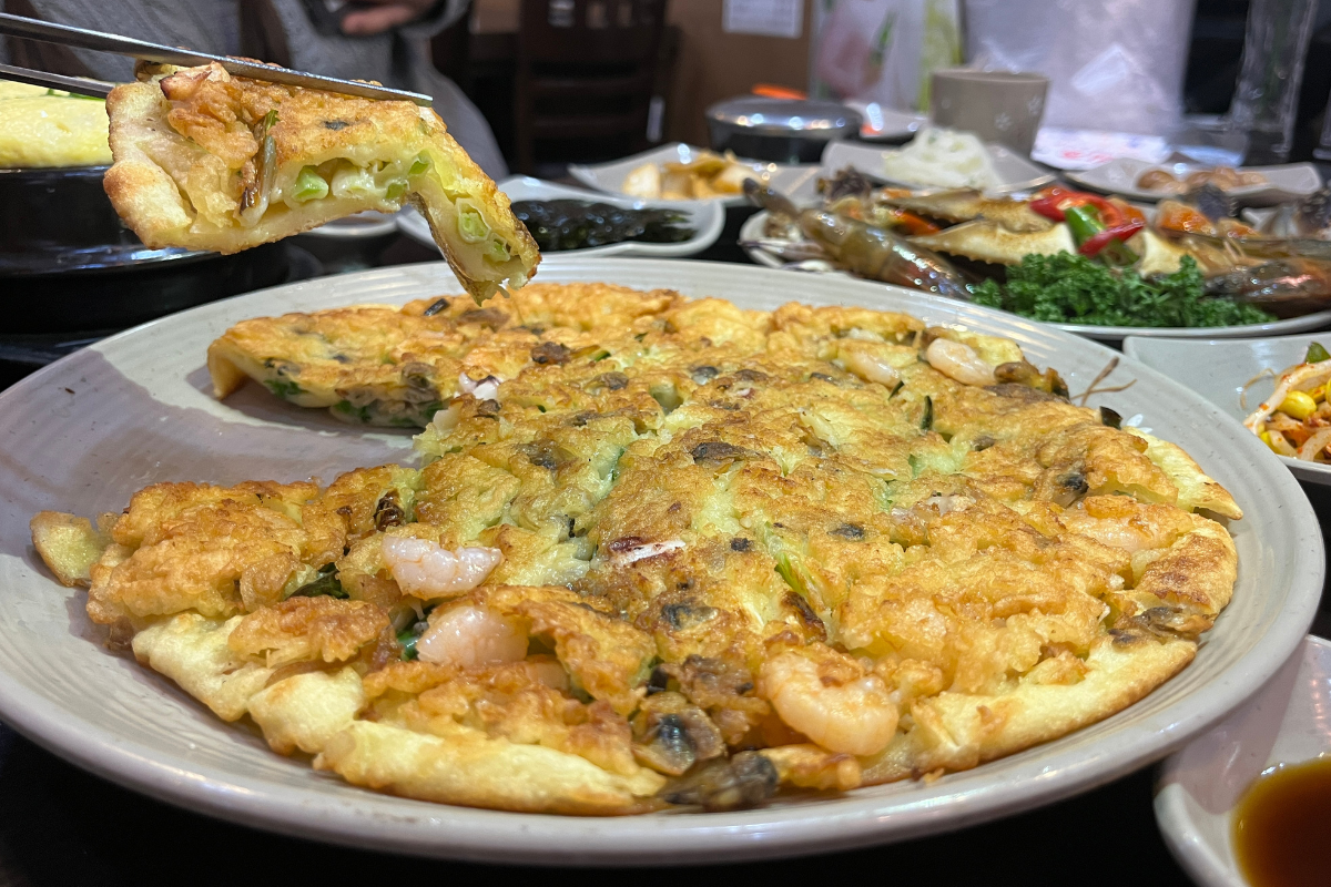 Fresh side dishes accompanying raw marinated crab at Hamcho Ganjang Gejang in Myeongdong, Seoul.