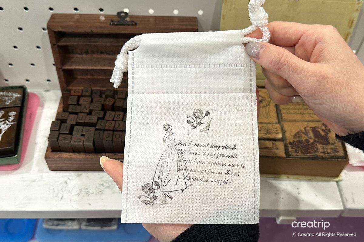 Green-tinted perfume bottle artfully styled with petals on a stone-textured background at Perfume Play Gangnam.