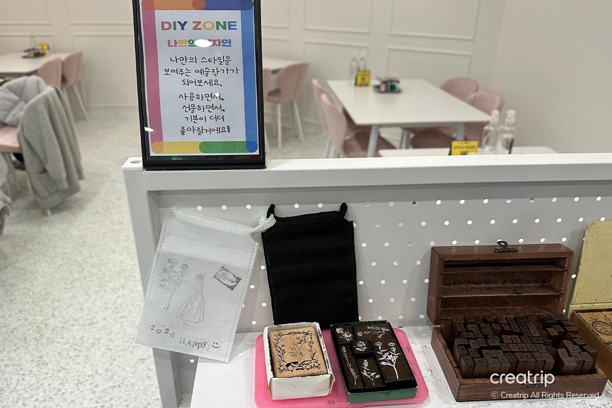 Aroma Forest perfume bottles elegantly styled with a feather and newspaper backdrop, captured at Perfume Play Gangnam.