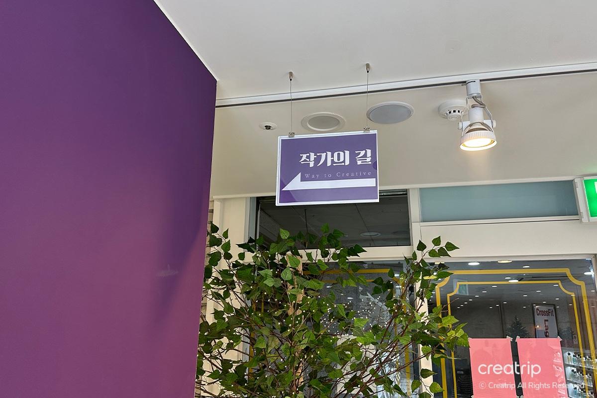 Amber-colored perfume bottle paired with a feather for an aesthetic display at Perfume Play Gangnam.