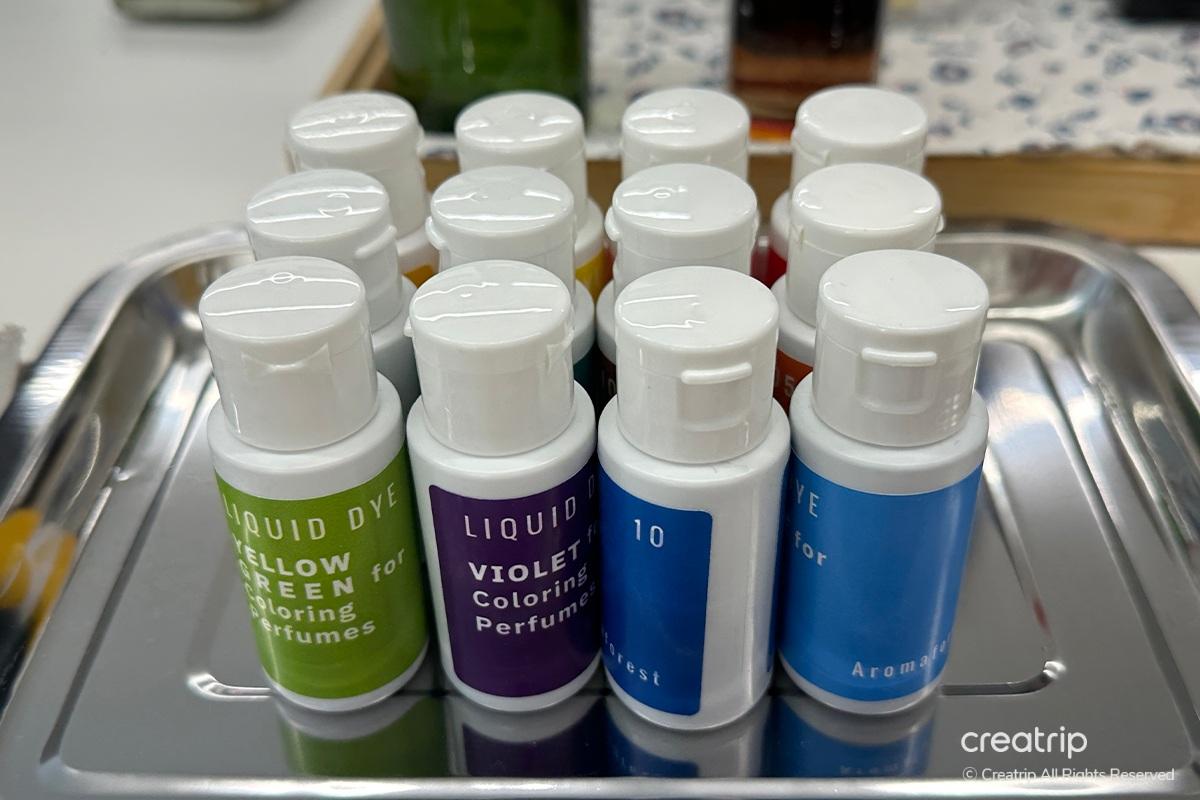 Decorated perfume bottle with stickers at Perfume Play Gangnam, showcasing a personalized fragrance creation.