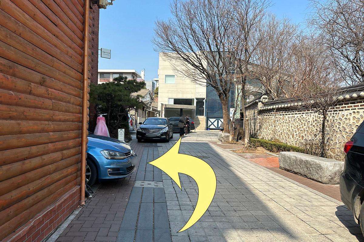 Tree-lined street leading towards Bukchon Hanok Village.
