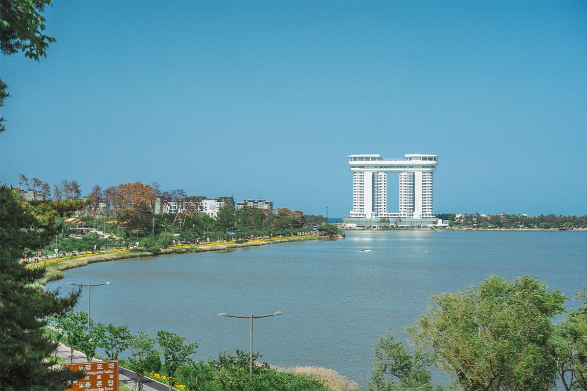 Boats docked at a riverside with a bridge in the background at Gangmun Beach, Korea.