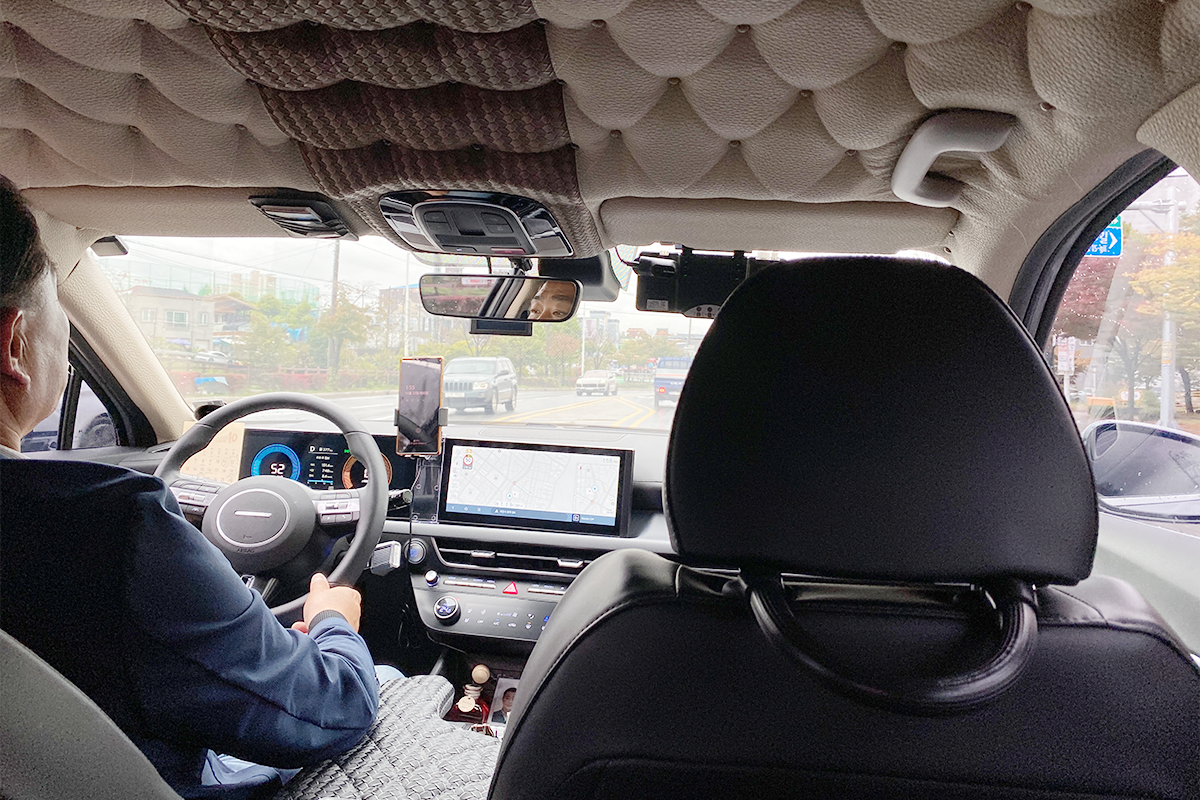 Scenic view through a private taxi's windshield during a Jecheon tour with navigation systems in view