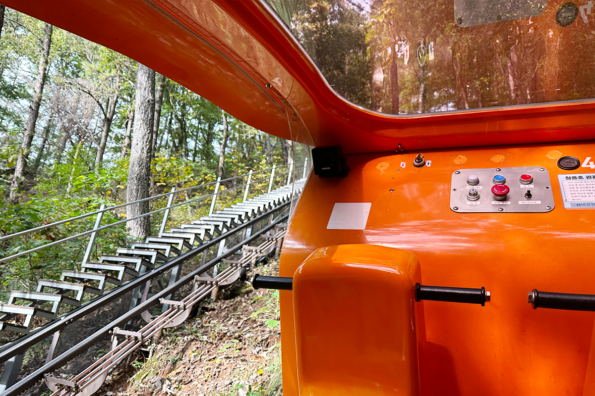 Breathtaking aerial view of Cheongpung Lake surrounded by mountains and green landscapes in Jecheon