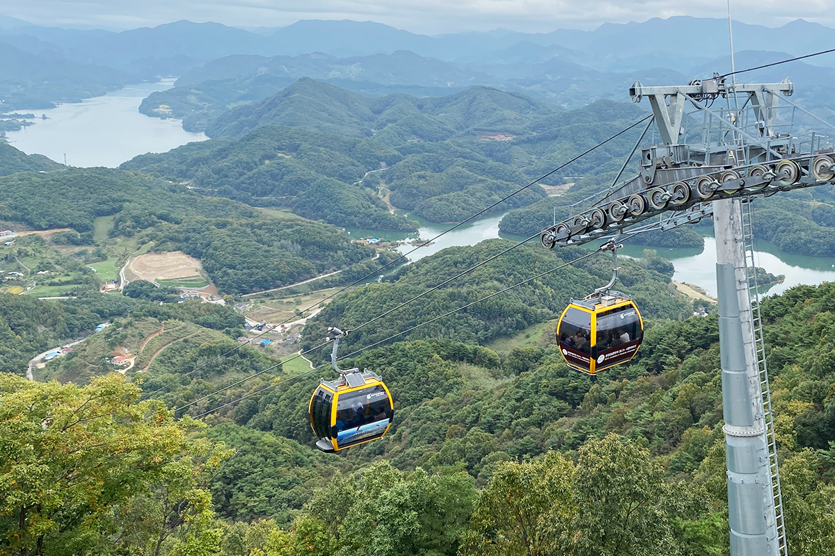Inside a cable car with panoramic views of Jecheon, overlooking Cheongpung Lake and mountains