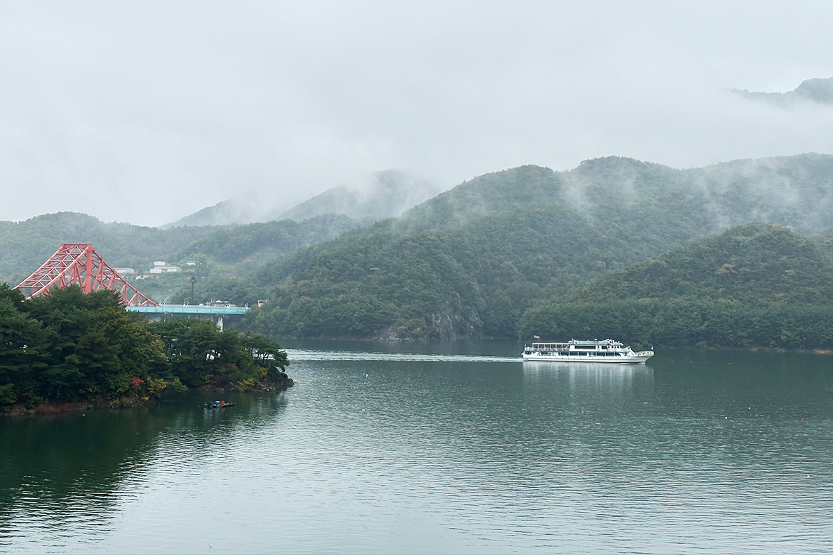 Sweeping view from Oksunbong Suspension Bridge overlooking Cheongpung Lake and majestic mountains in Jecheon