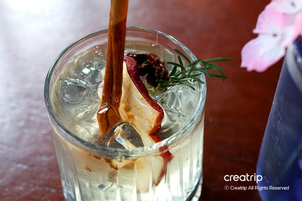 Chopsticks lifting a portion of spicy grilled chicken feet at Earl, Hongdae.