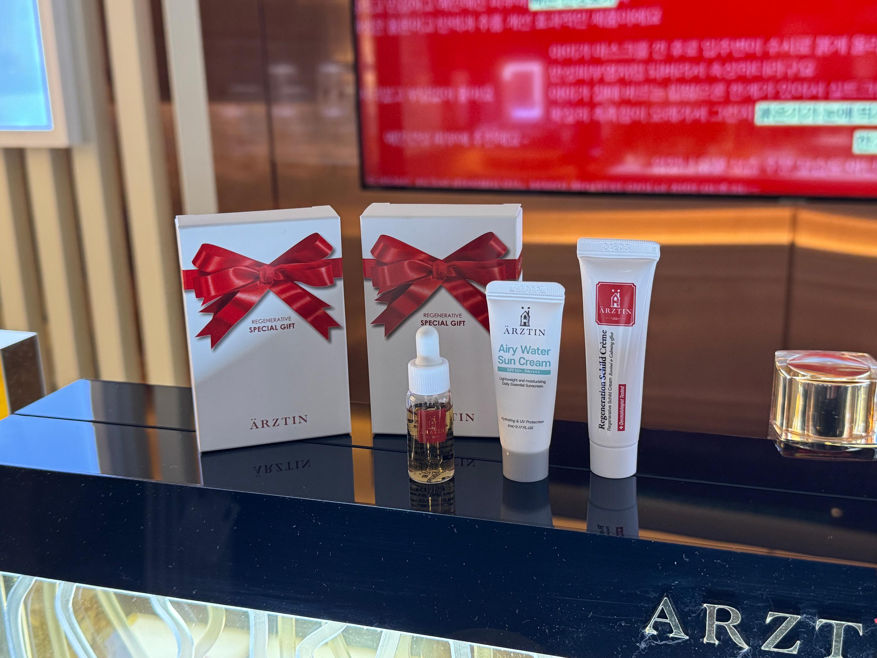Display of ARZTIN regenerative skincare products available as part of a treatment package.