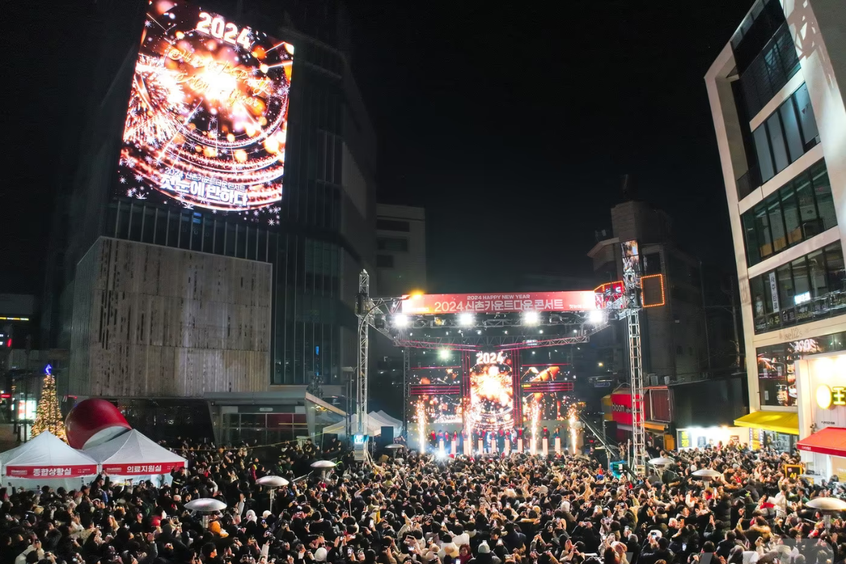 Sinchon Countdown Concert in Seoul celebrating New Year's Eve with a large crowd and live music.