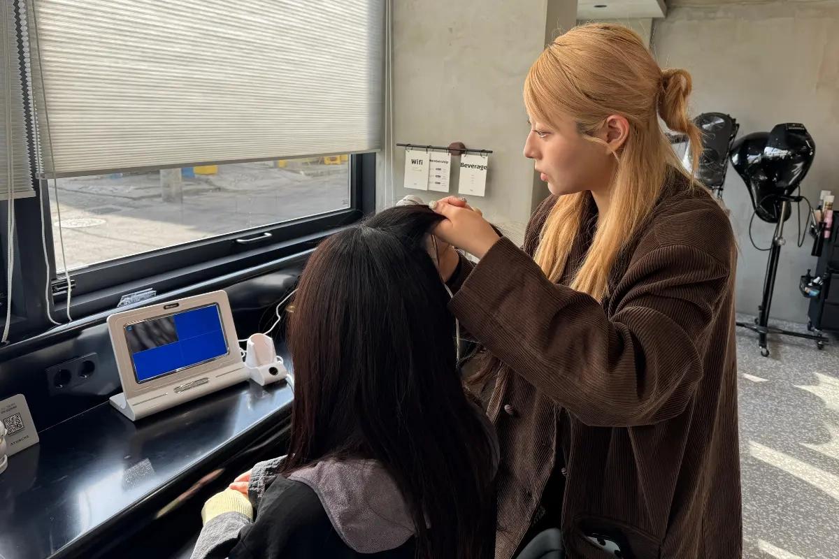 Stylist examining client