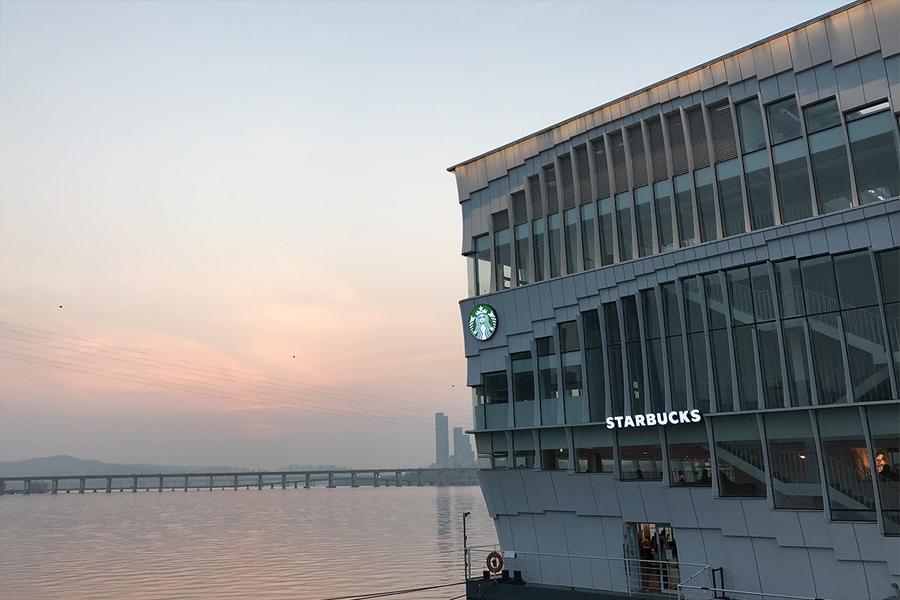 view of sunset and starbucks from walkway of seoul wave art center 