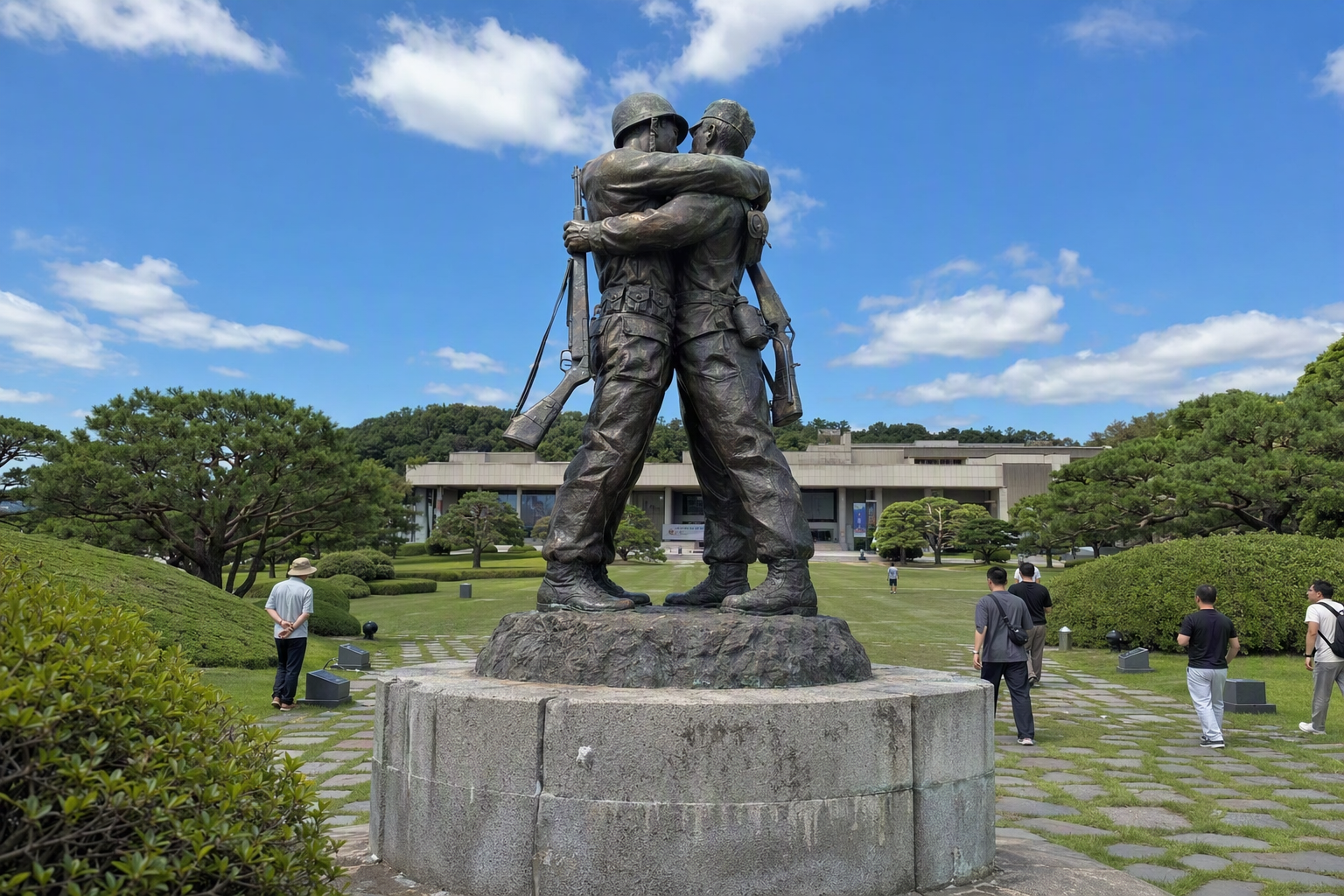 Bright photorealistic Statue of Brothers at the War Memorial, emotional embrace sculpture, blue sky, green lawns, no Korean text