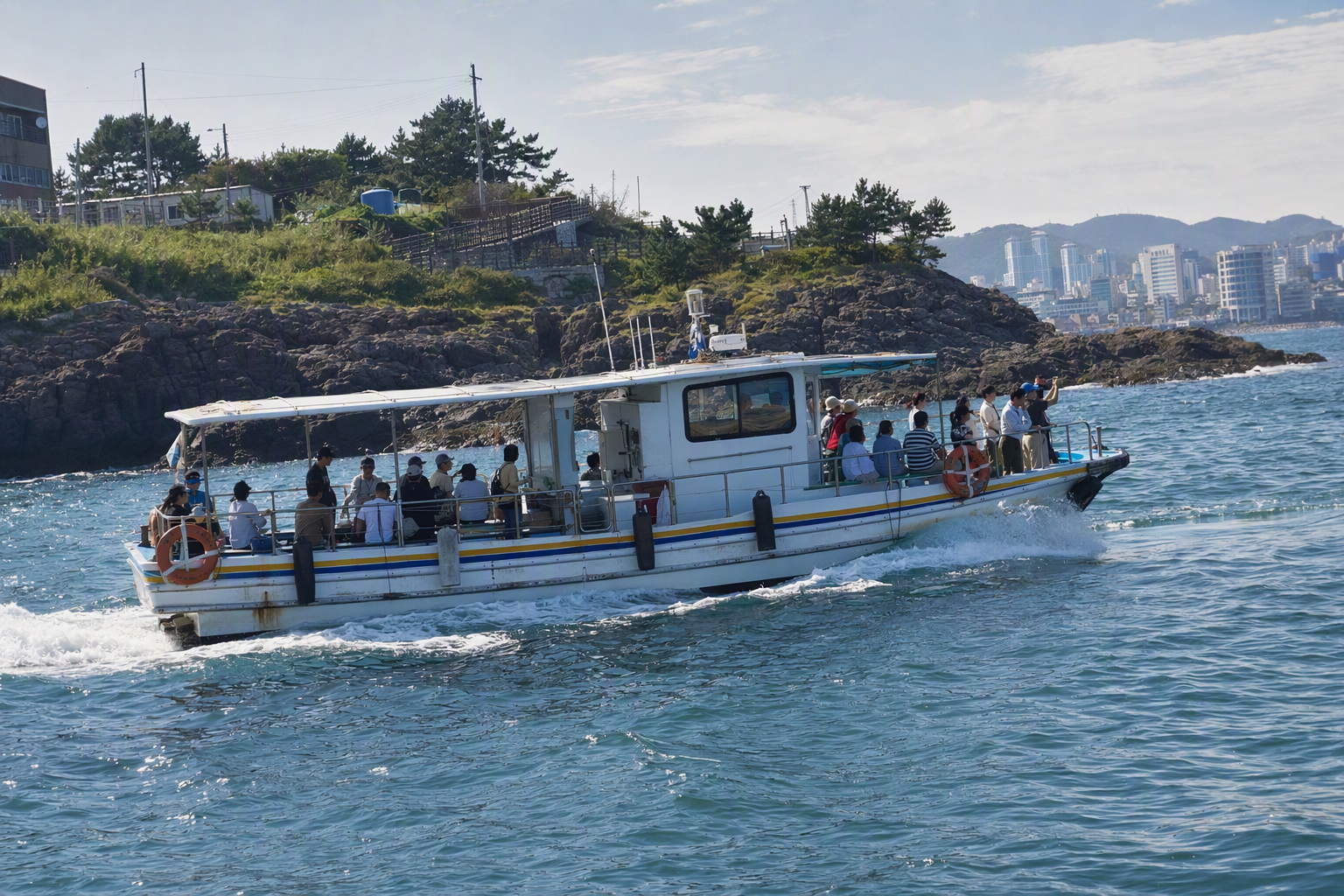 Bright photorealistic shot of a small coastal ferry cruising past rocky shoreline and blue water, passengers on deck, sunny skies