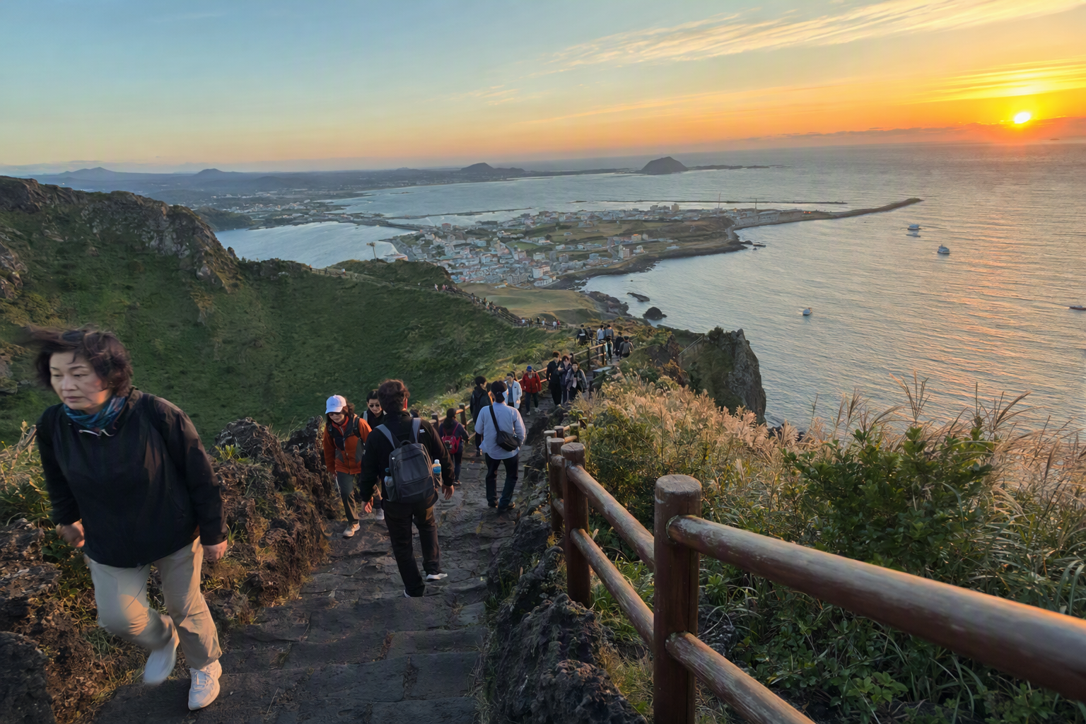 Bright photorealistic sunrise view from Seongsan Ilchulbong with a volcanic crater ridge, ocean horizon, soft golden light, and hikers on stone steps, no text