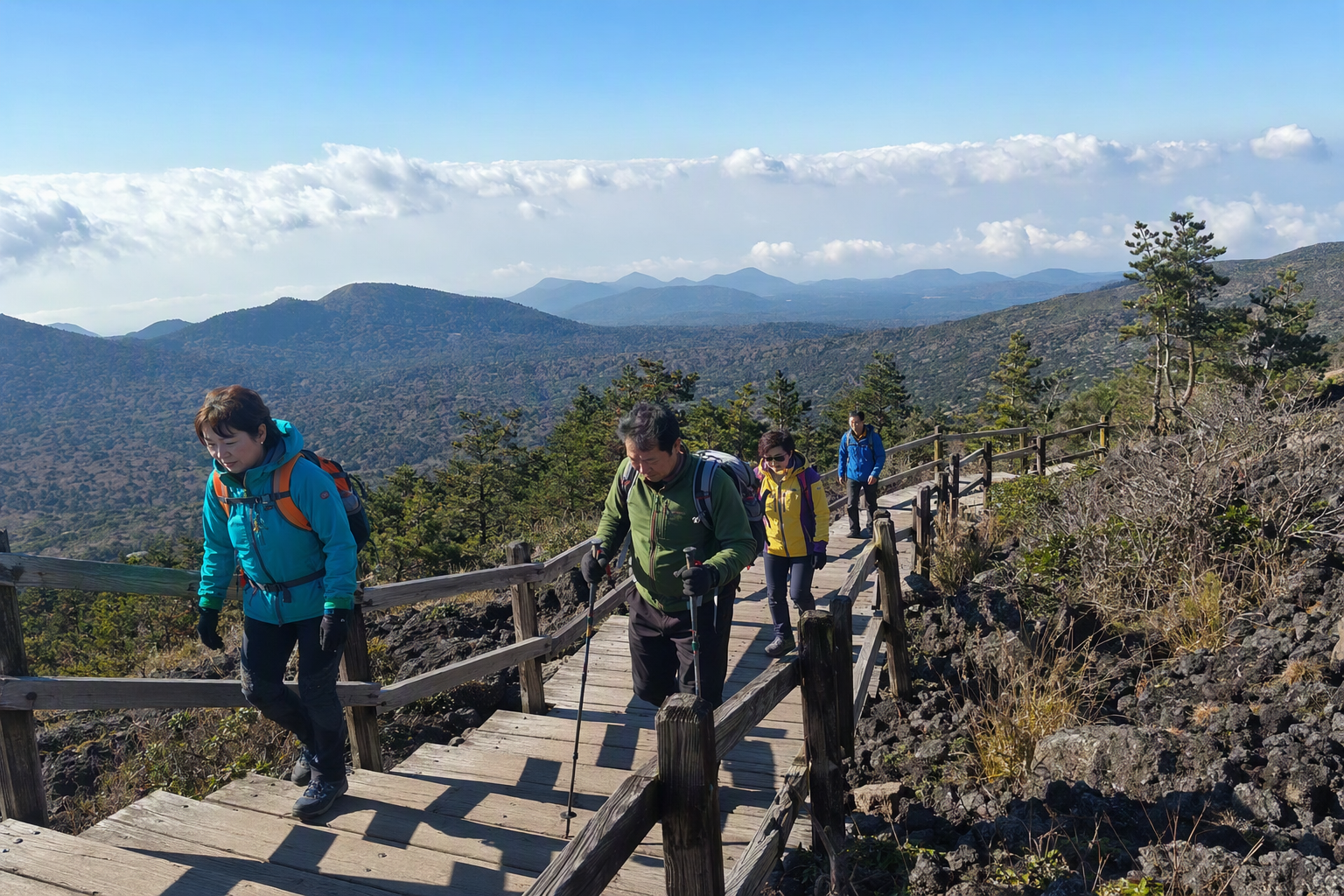 Bright photorealistic Hallasan hiking trail with wooden steps, alpine shrubs, distant clouds, and hikers wearing light jackets under crisp blue sky, no text