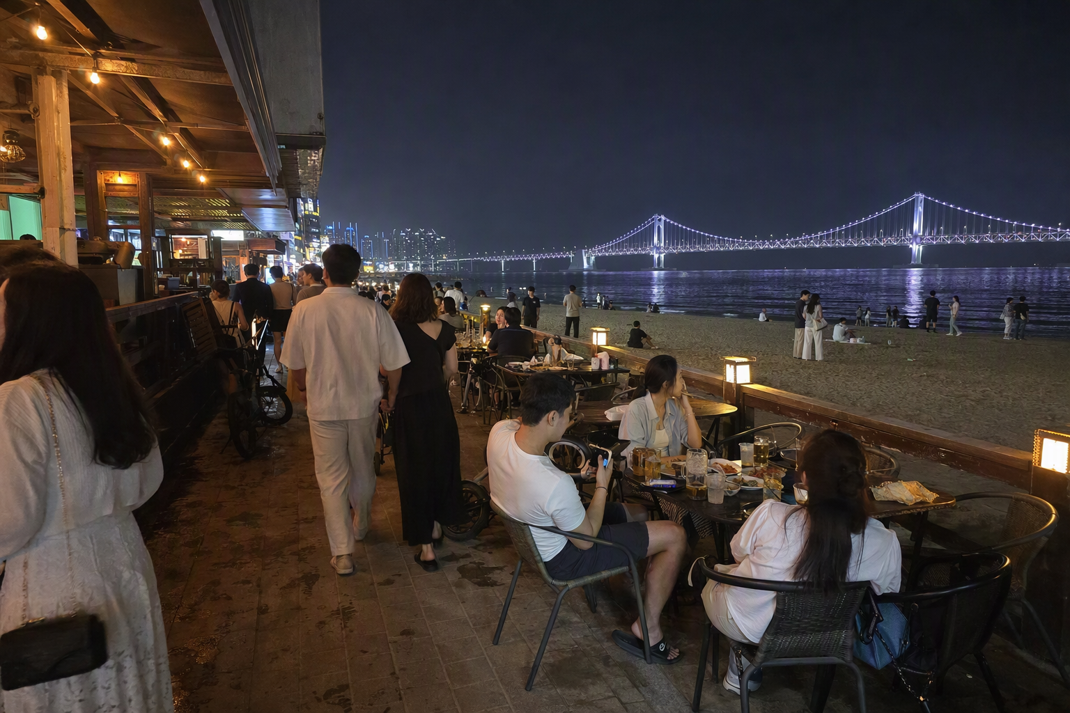 Bright photorealistic beach bar street near Gwangalli at night, glowing bridge across the water, outdoor tables, warm lights, stylish travelers, no visible text