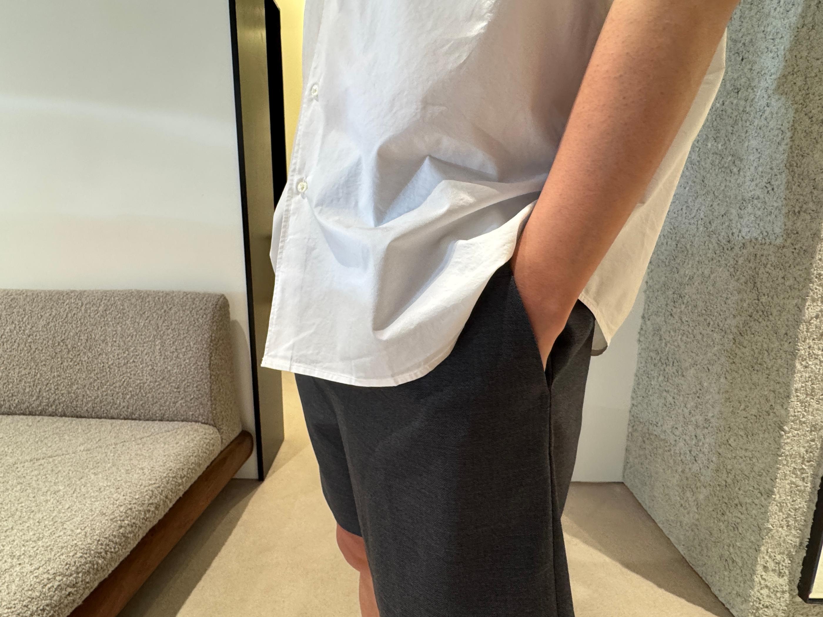 Styled Pottery summer outfit: relaxed-fit white linen shirt and tailored navy shorts displayed on a minimalist rack