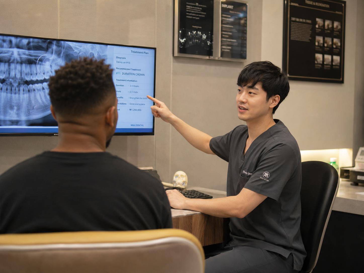 Image of a dentist showing a patient their teeth on a monitor while explaining the number of visits and the treatment plan