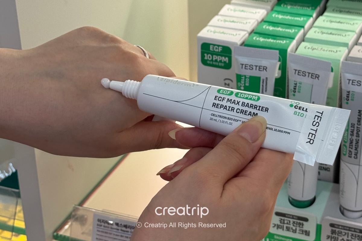 Squeezing Zipiderm EGF Max Barrier Repair Cream onto the back of the hand