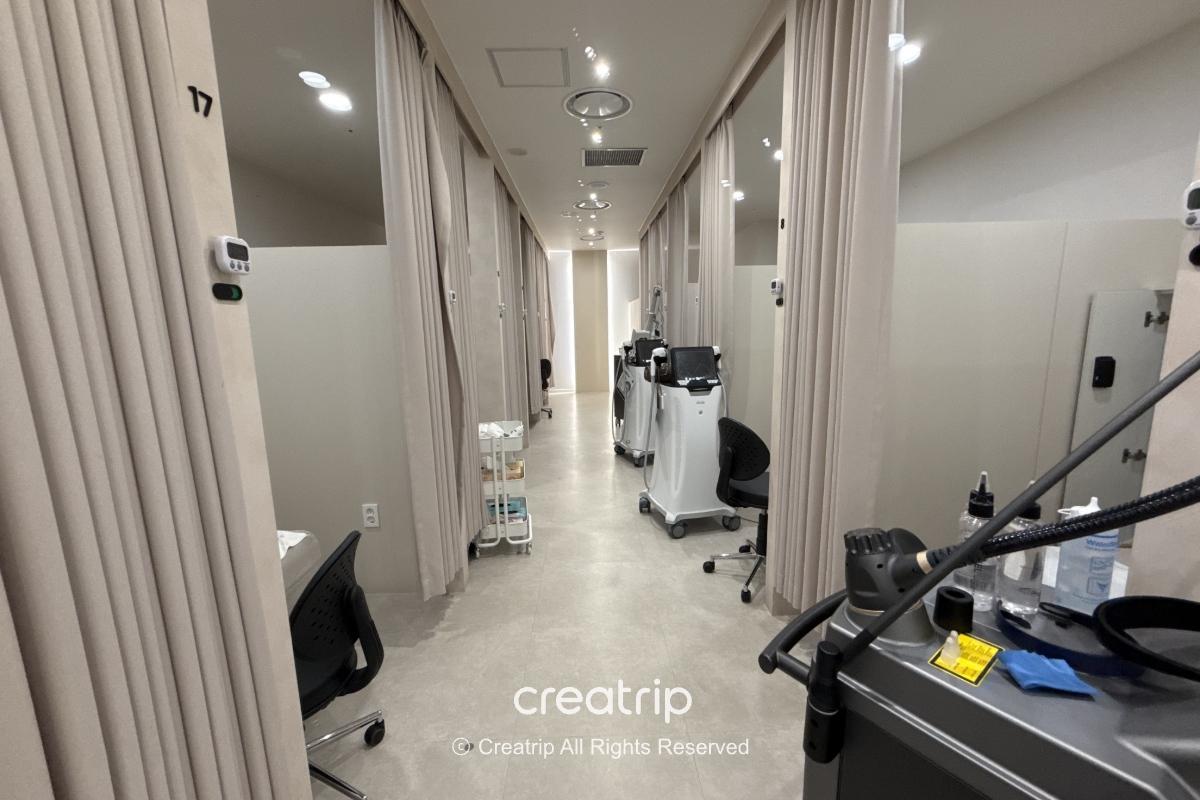 Private treatment room with bed and medical cart