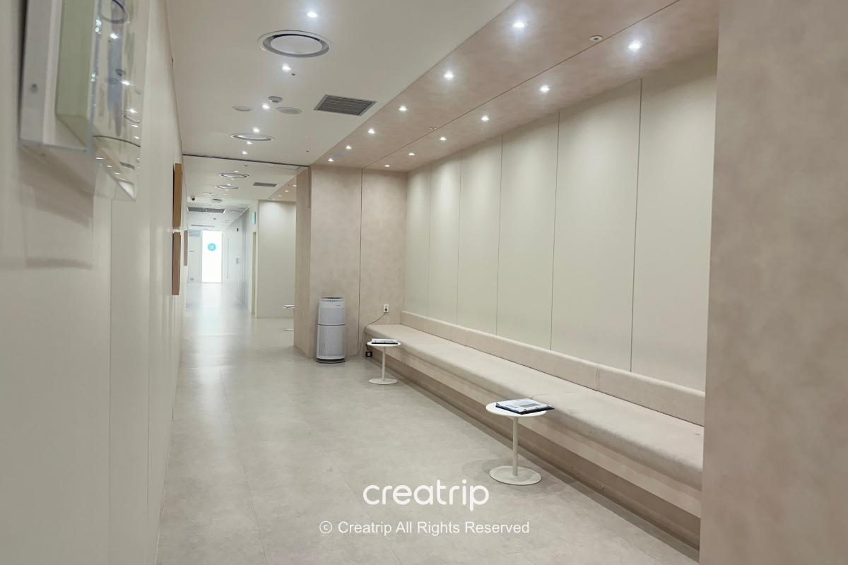 Clinic hallway with a long built-in bench and ceiling lights