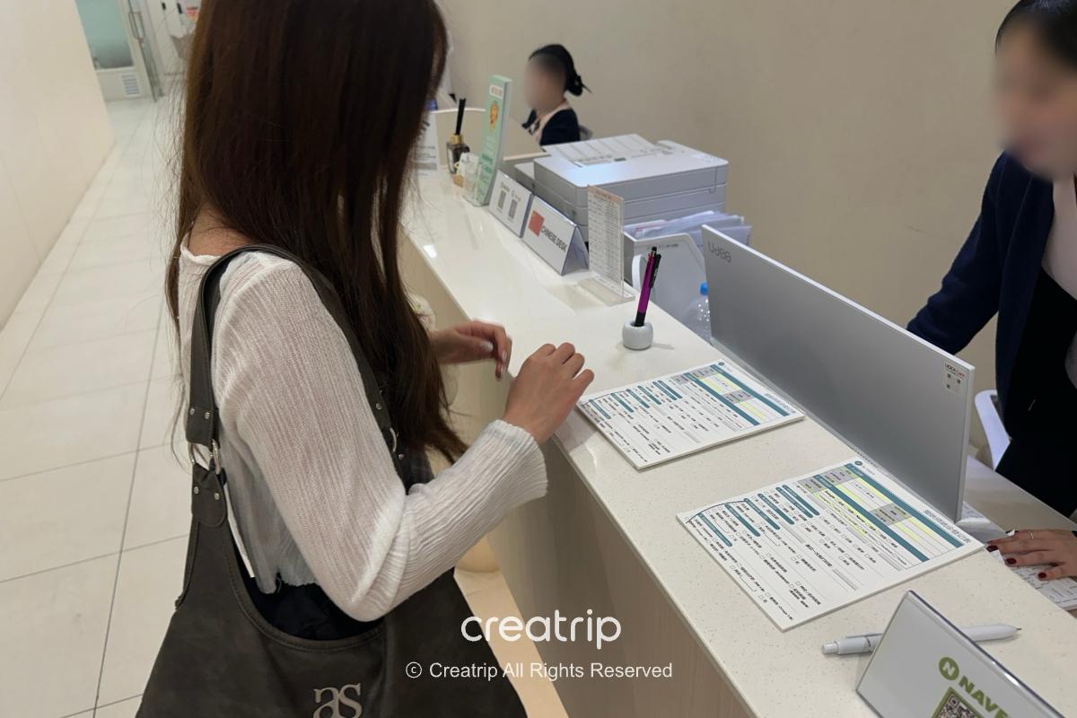 Visitor and consultant reviewing information at a desk
