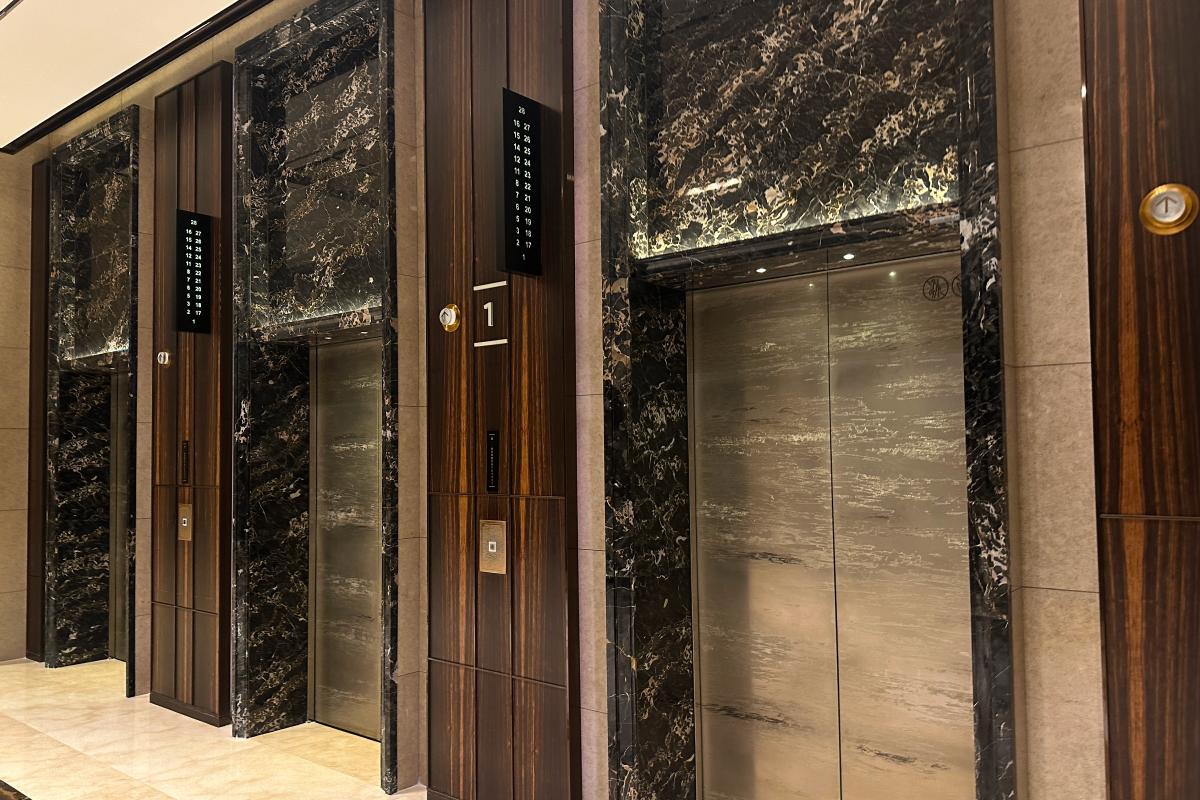 Hotel elevator lobby with dark marble walls