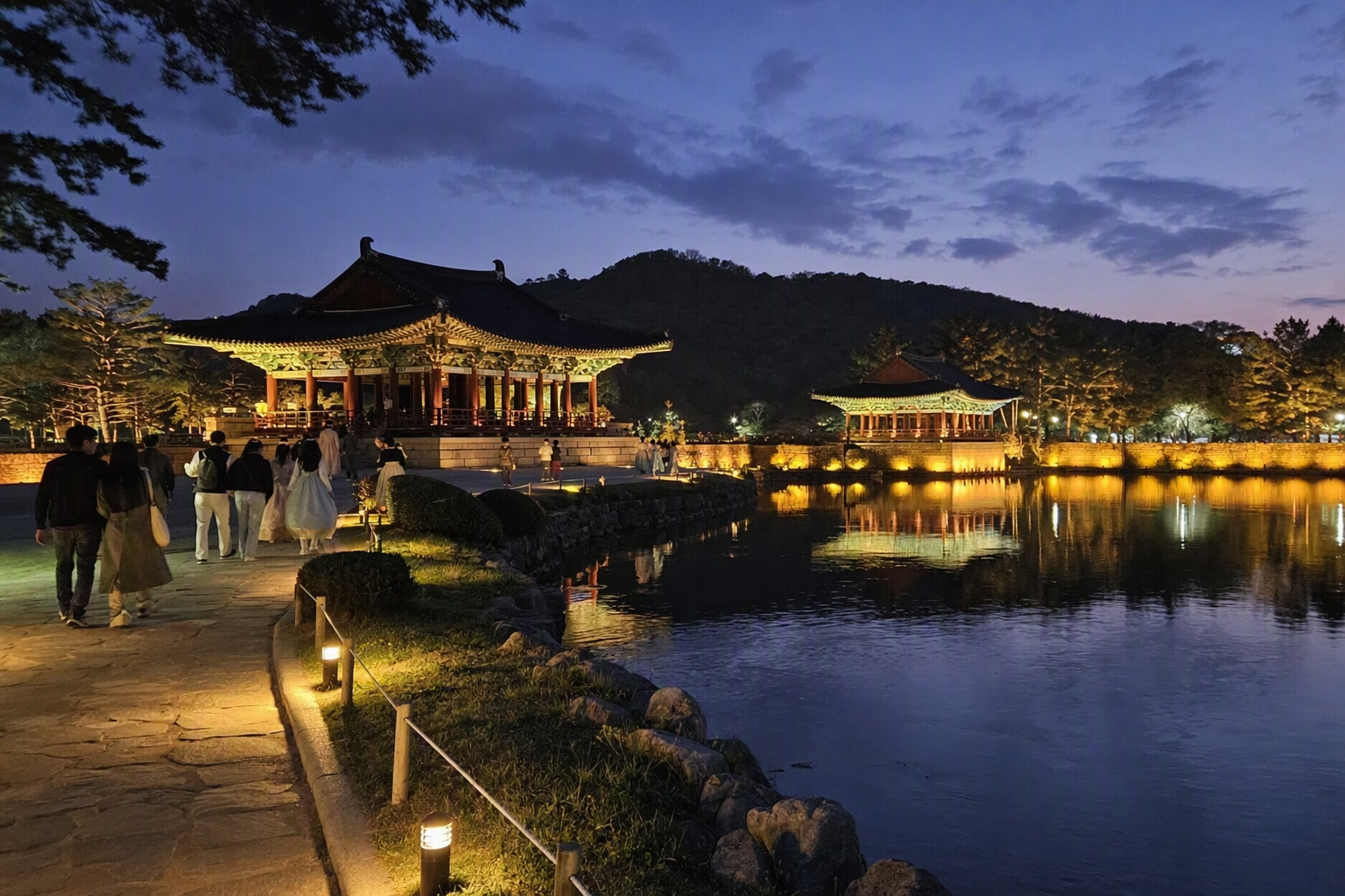 Bright, vibrant, photorealistic evening view of Donggung Palace and Wolji Pond in Gyeongju with glowing reflections, calm water, and historic architecture, no K