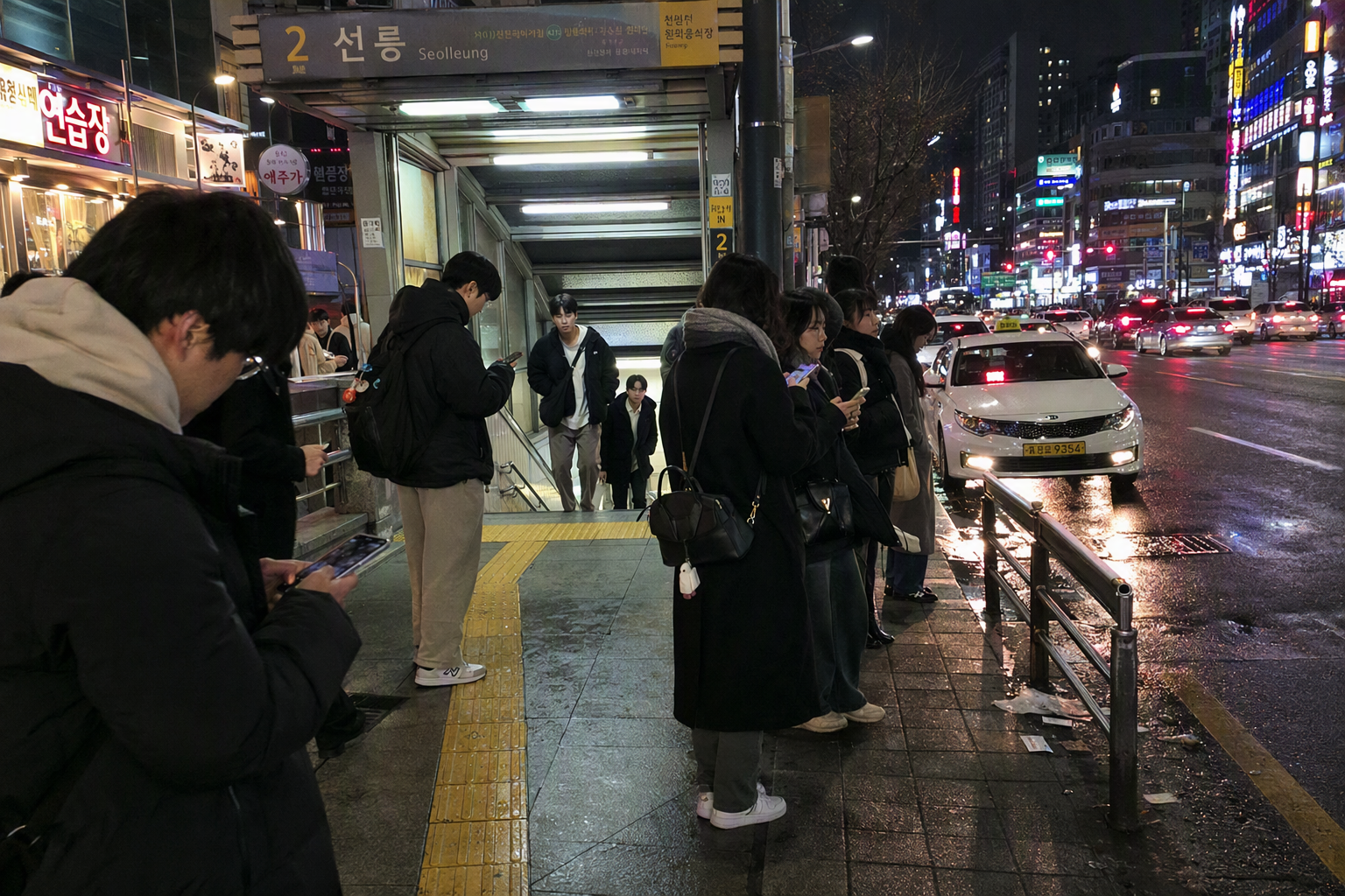 Bright vibrant photorealistic Seoul subway entrance at night near a nightlife district, people checking phones, taxis passing by, neon reflections on wet paveme