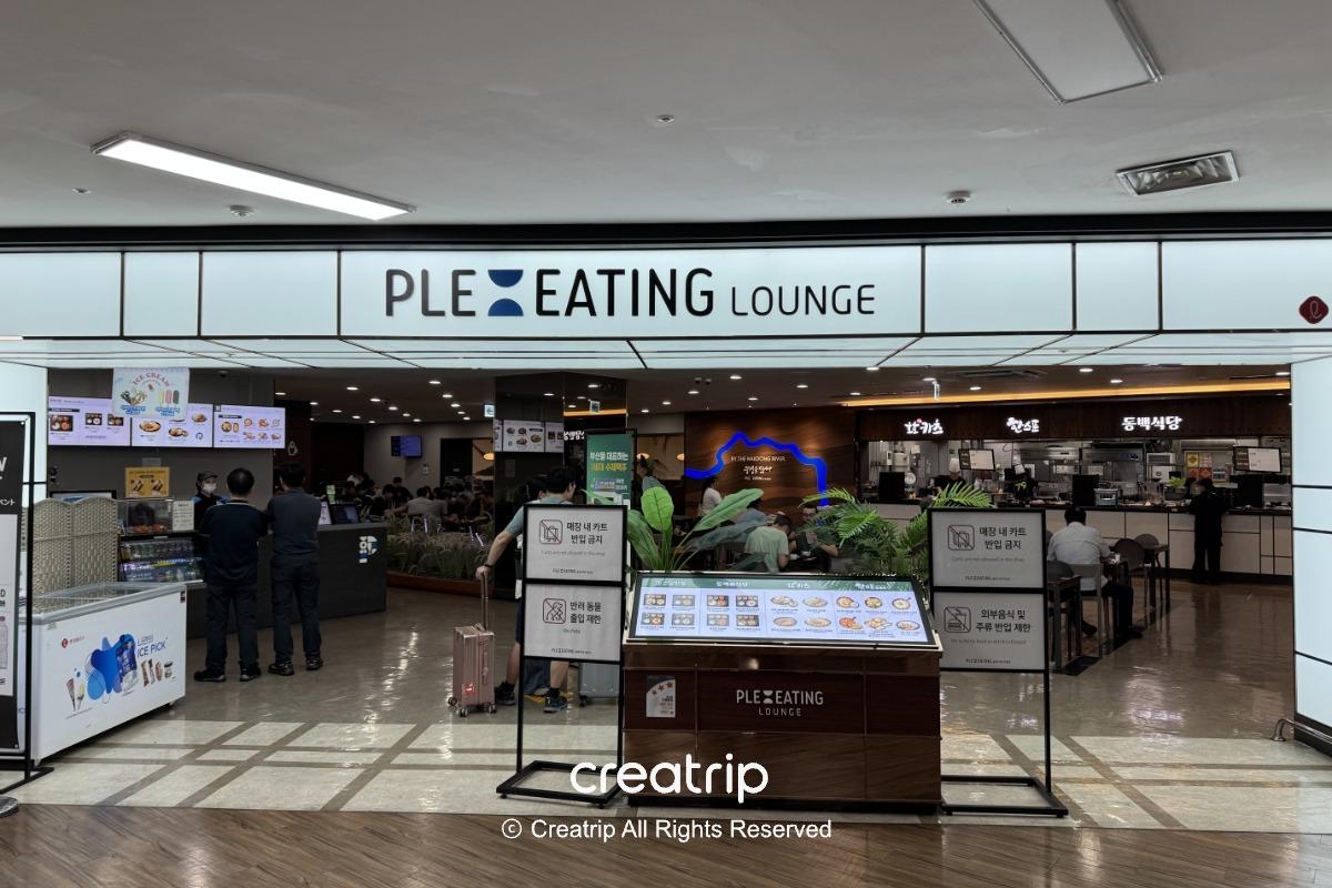 釜山金海機場PLE: EATING美食街入口，招牌燈箱、菜單展示與座位區可見，適合搭機前後用餐或快速外帶的餐飲區導覽照。