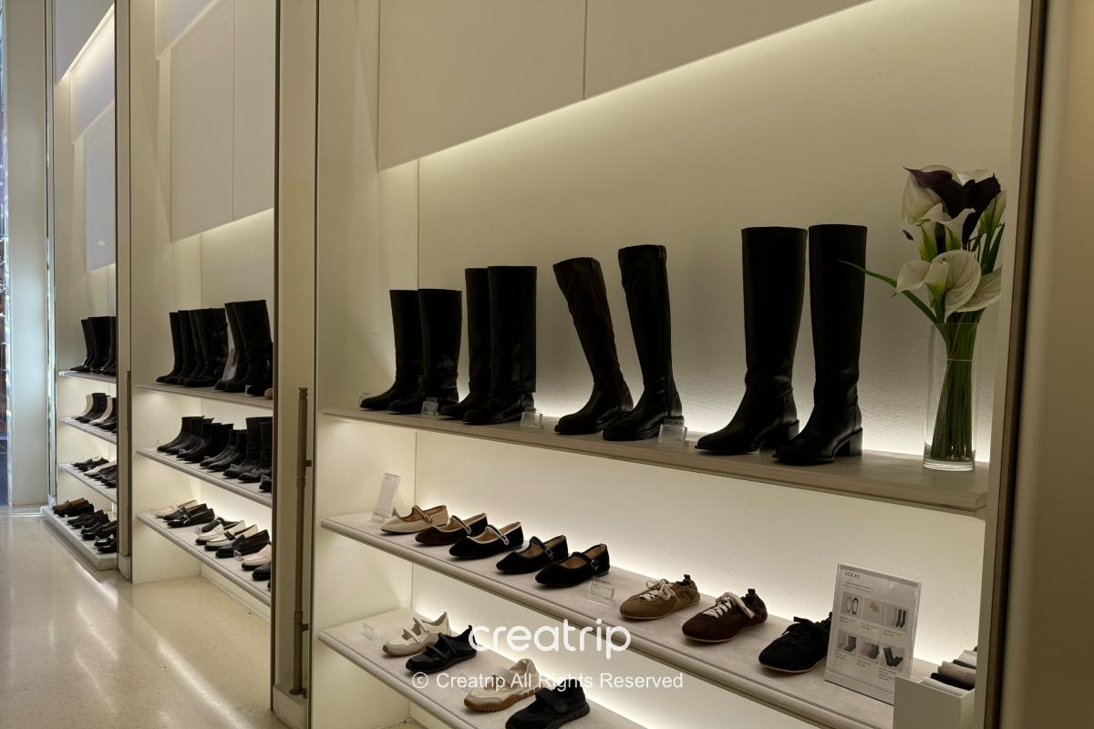 Women’s loafers in black, white, and neutral colors on display