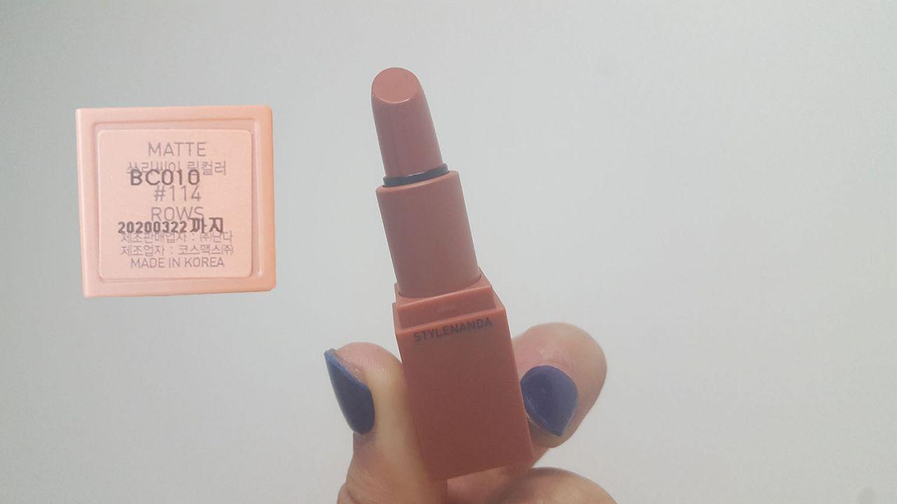 Applying 3CE lipstick shade #114 ROWS, a neutral nude perfect for runway looks.