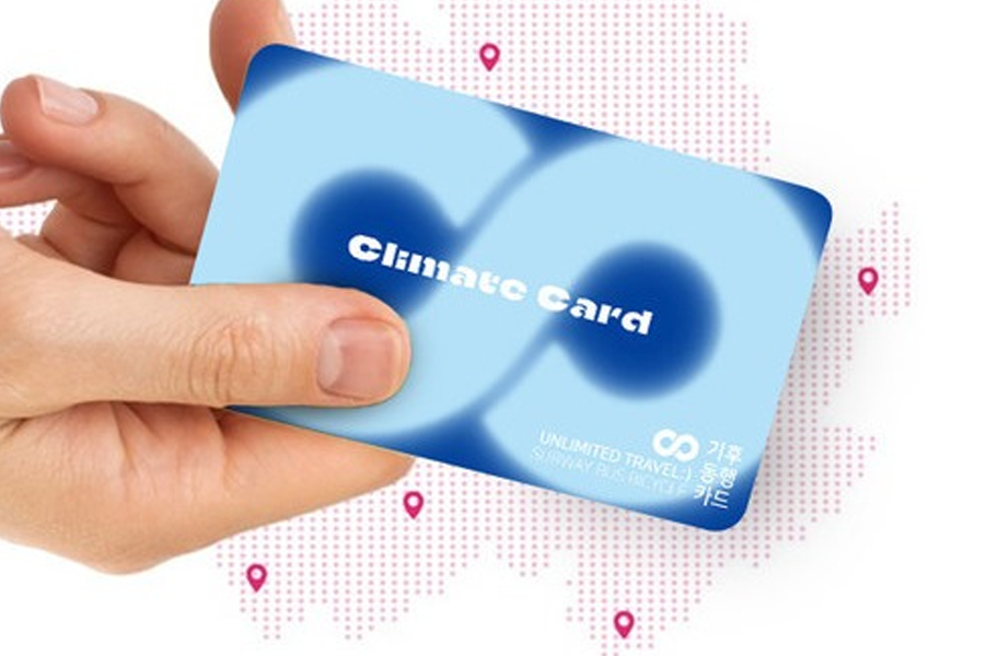 Holding the Seoul Climate Card, a subway and bus pass offering unlimited travel in the city, part of sustainable transport efforts.