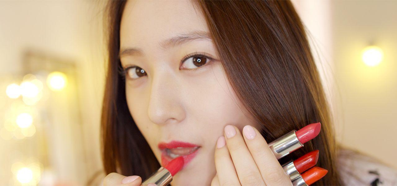 Assortment of bright lipsticks held in hand, illustrating the array of shades available from Etude House.